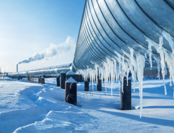 steel pipe gas line in winter with icicles hanging snow pipe and tube in the cold