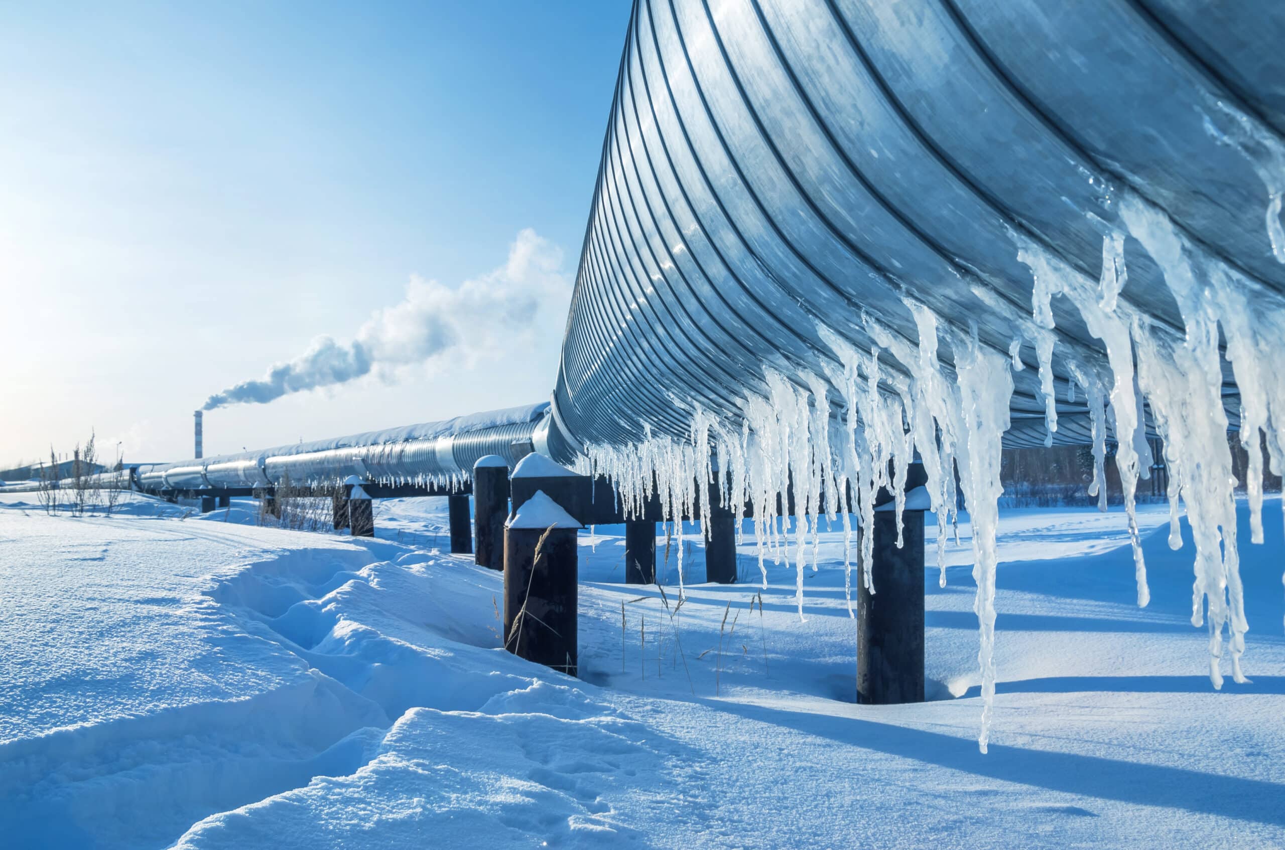 steel pipe gas line in winter with icicles hanging snow pipe and tube in the cold