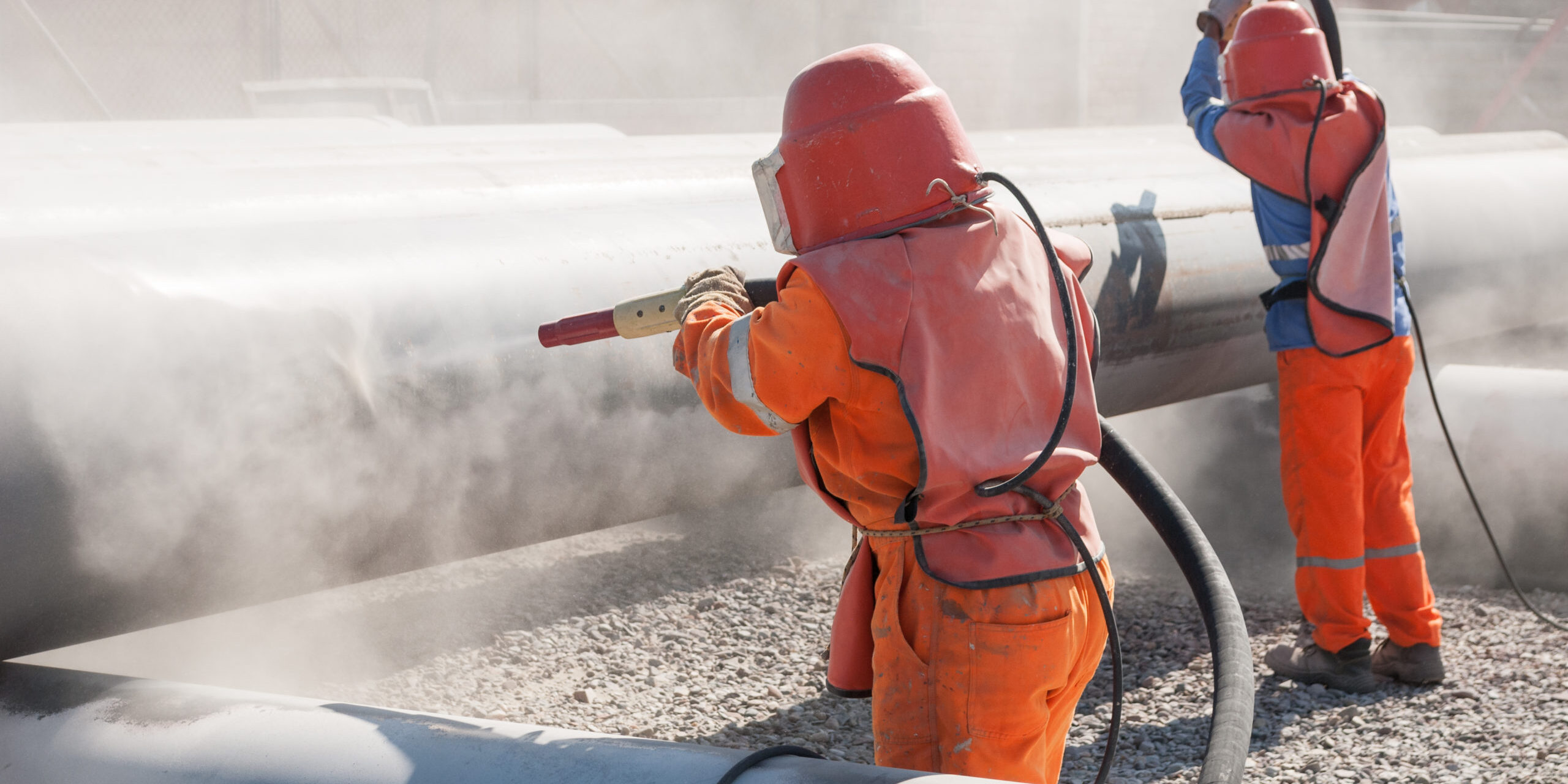 Uniformed,Workers,Performing,Sandblasting,Process